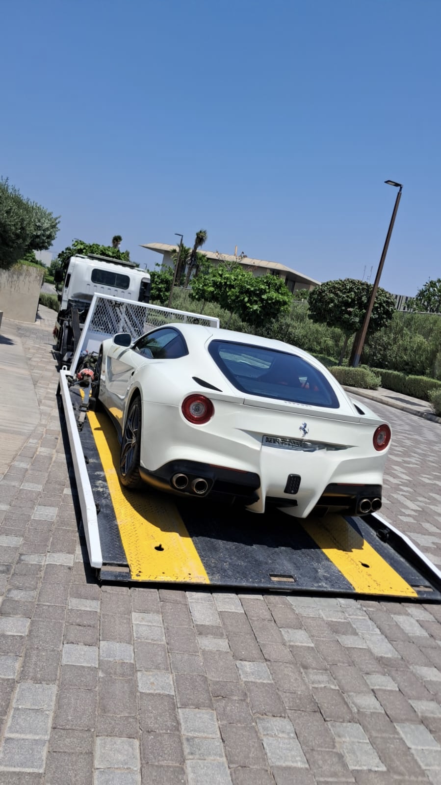 Ferrari F12 loaded on a flatbed tow truck in Dubai
