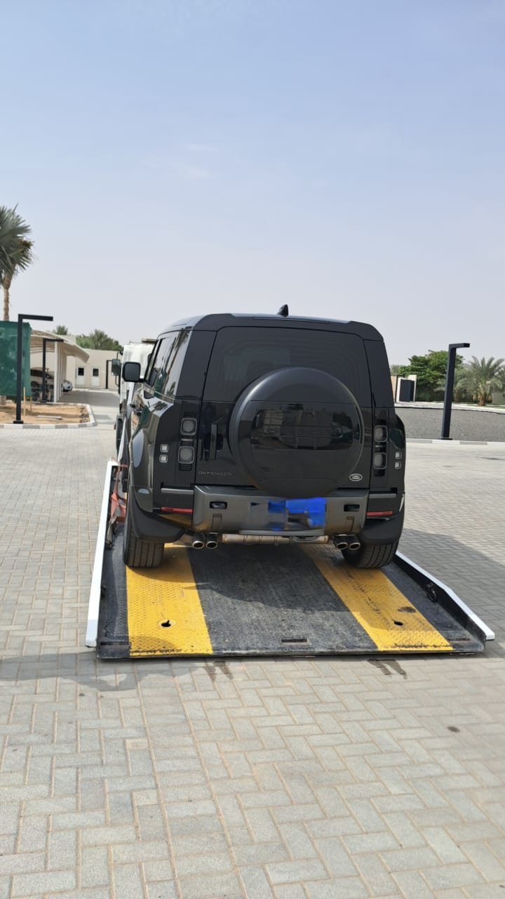 Land Rover Defender on a flatbed recovery truck in Dubai